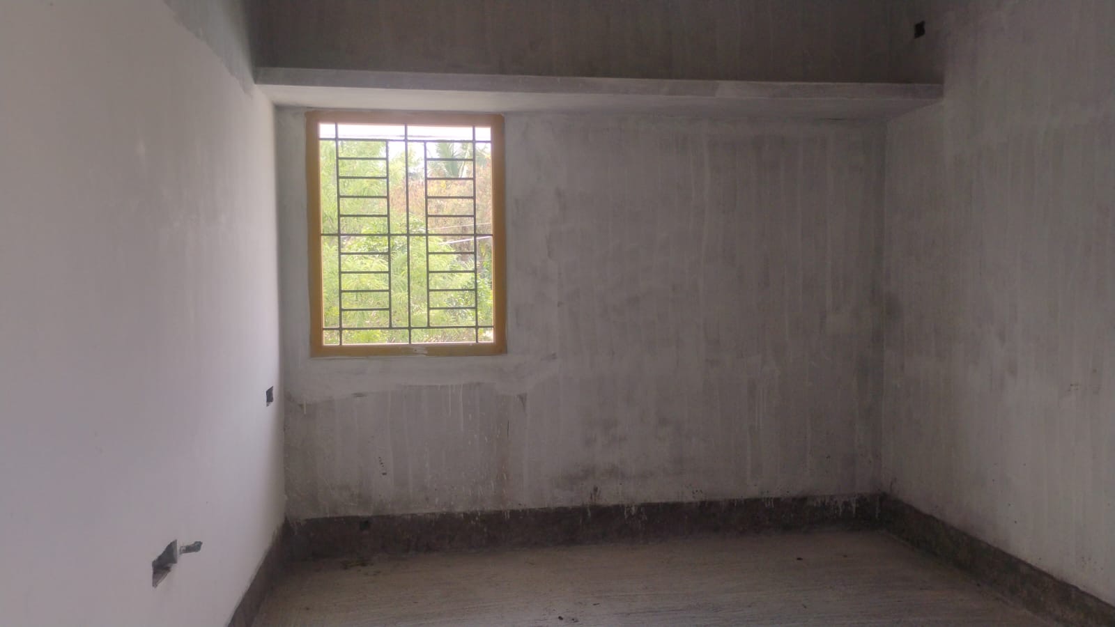 Bare room before work begins, plastered walls and screed floor