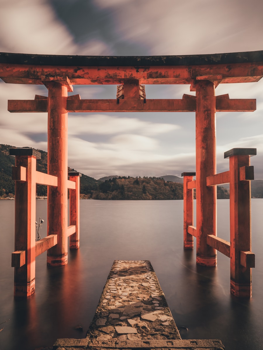 Japanese theme — vermilion torii gate over still water at Hakone